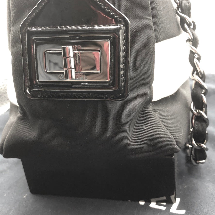 black leather chanel handbag white